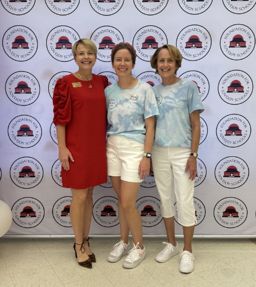 Allen orthodontist Doctor Megan Hanson smiling with two women at an event for the Foundation for Lovejoy Schools