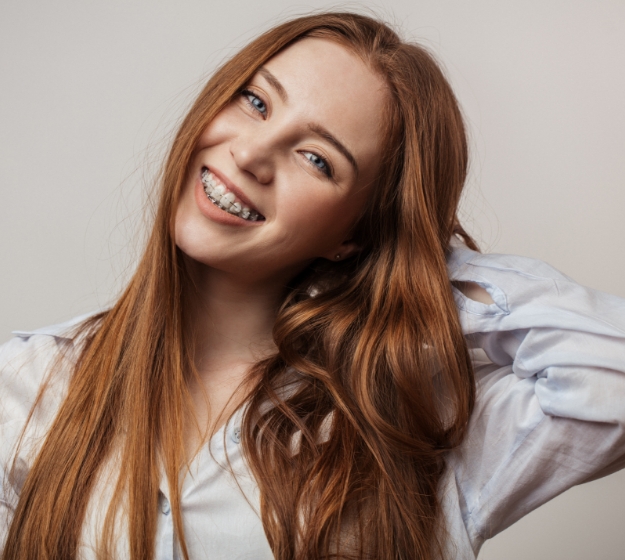 Close-up of person’s smile with clear ceramic braces