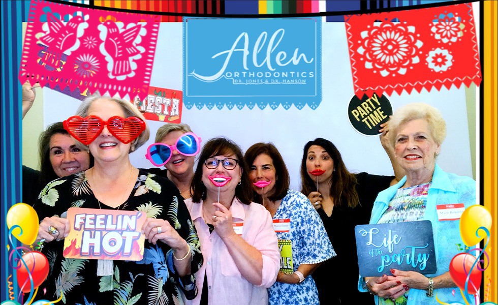 Orthodontic team members with silly props in a photo booth