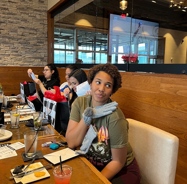 Woman at restaurant showing off her new gloves