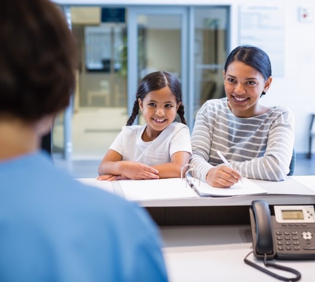 Orthodontic patients reviewing dental insurance coverage