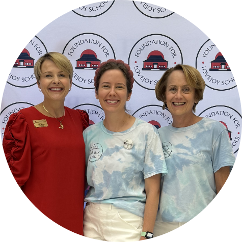 Doctor Hanson smiling with two women at an event for the Foundation for Lovejoy Schools