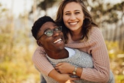 Teen boy and girl hugging outdoors