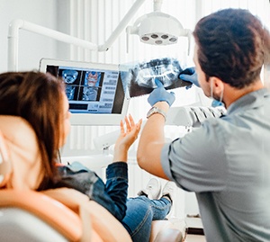 Allen orthodontist showing a patient an xray of their teeth