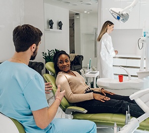 Woman smiling at orthodontist during Invisalign consultation