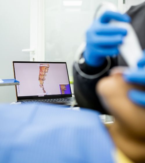 Orthodontist taking digital impressions of a patients teeth