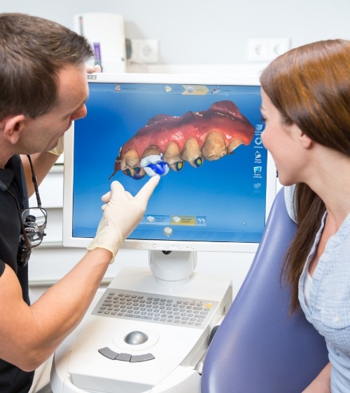 Dentist showing a patient a screen with a digital impression of their teeth