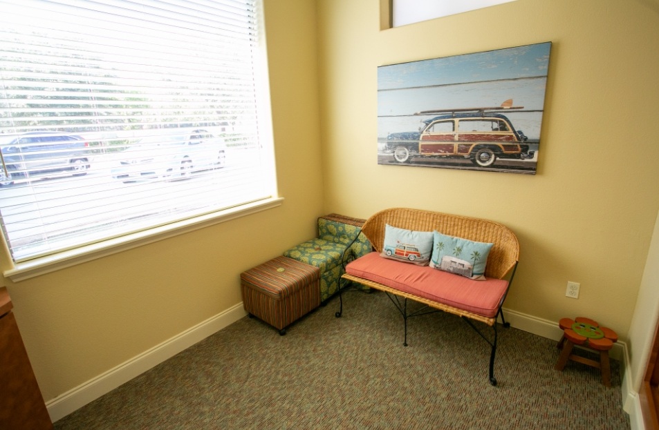 Window of reception area next to a wall with art of a station wagon