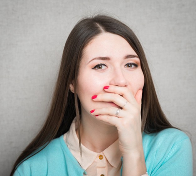 Woman covering her mouth with her hand