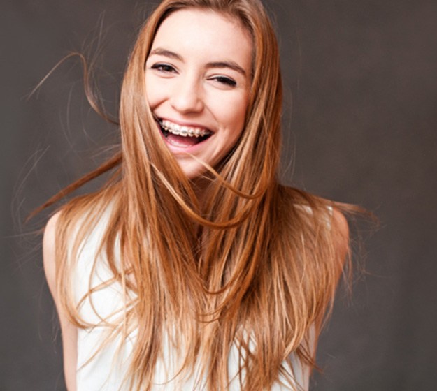 Smiling young woman with braces