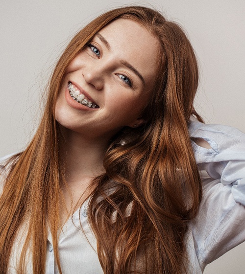 young girl smiling with clear braces