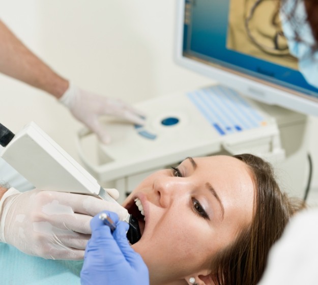 Patient having digital scans of her teeth taken by orthodontist