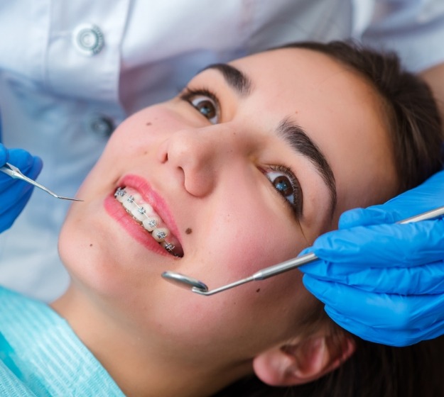 Woman with braces at a dental checkup