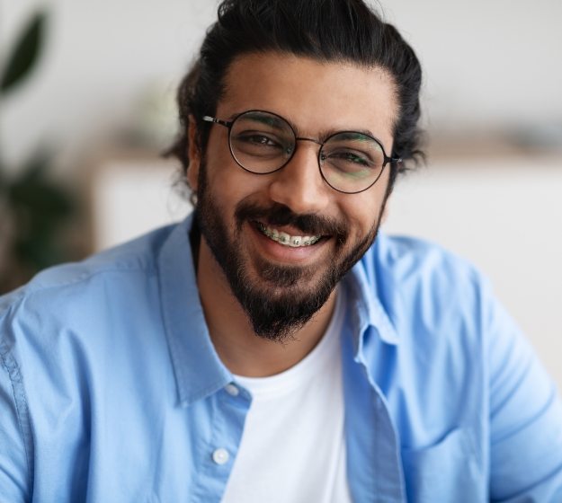 Man with beard and braces smiling