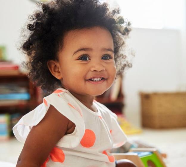 a child smiling with nice and healthy teeth